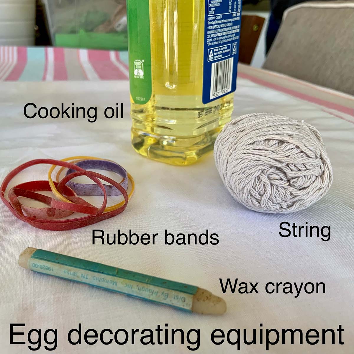 Equipment for decorating dyed eggs: cooking oil, rubber bands, string and wax crayon